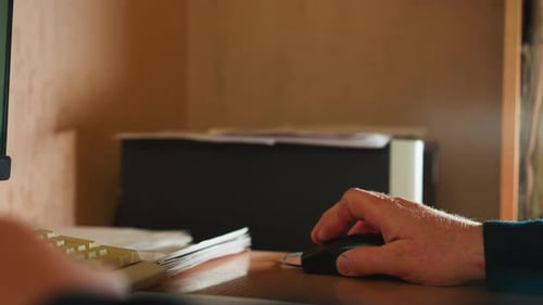 Office Worker Uses Mouse Working on Computer at Desk