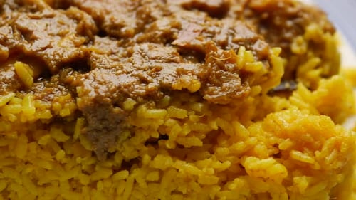 Boiled Yellow Rice with Meats on a Plate