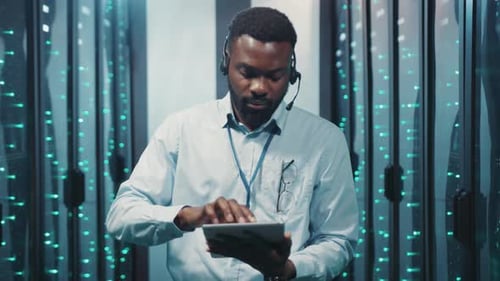 Man using tablet in a server room