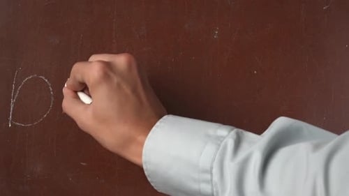 Hand Writes Deltacron on a Brown Surface