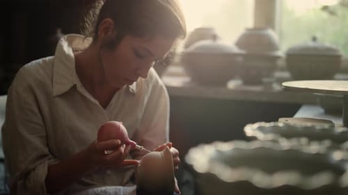 Portrait Of Focused Woman Putting Ornament On Product In Workshop. Closeup Serious Female Artist ...