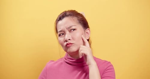 Contemplative Woman Thinking with Yellow Background