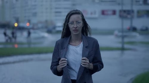 Young Businesswoman is Walking in the City While It is Raining