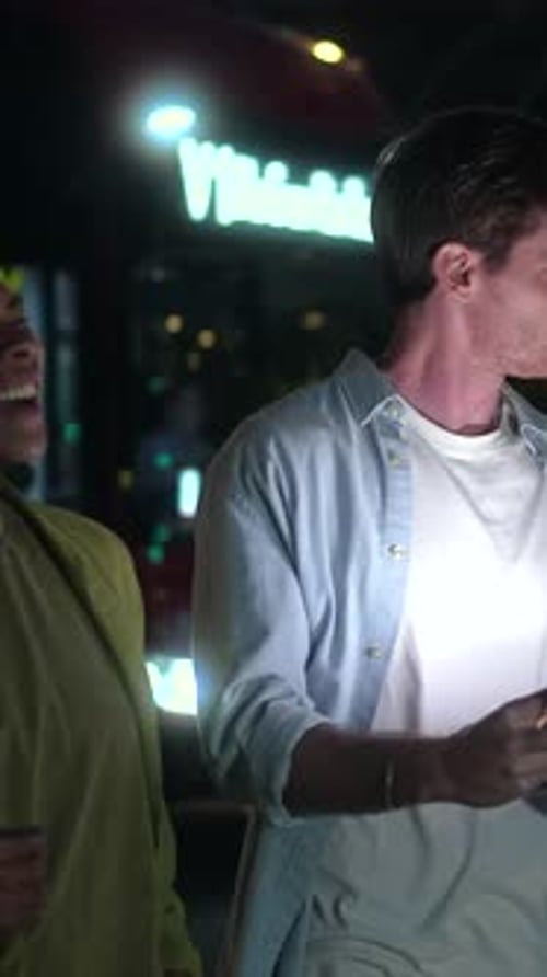 Diverse Friends Socializing and Using Tablet at Night in the City