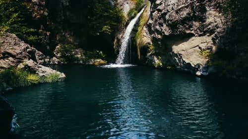 Magical mountain waterfall, crystal water, large stones . The waterfall with the crystal clear water