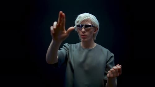 Man with futuristic glasses interacts with virtual display