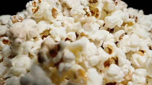 A pile of popcorn rotates in close-up.