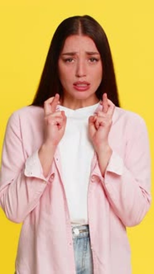 Woman Crossing Fingers Closing Eyes Hoping for Luck Positive Emotion Wishful Thoughtful Expression