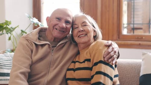 Loving Senior Couple Embracing in their Home