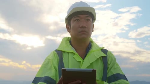 a man engineer is wearing a protective helmet