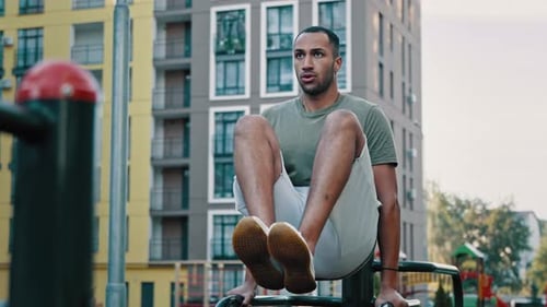 Powerful Latina Sportsman Gymnast Muscular African American Healthy Man Lifting Legs on Bars City