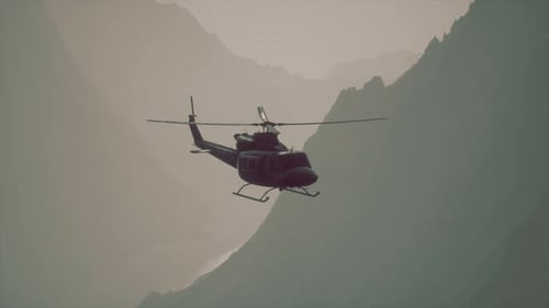 A Helicopter Flying Over a Mountain with a Sky Background