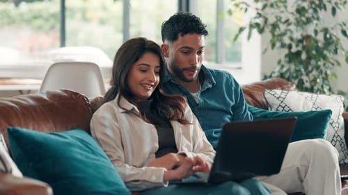Relaxed Couple Enjoys Laptop at Home on Couch