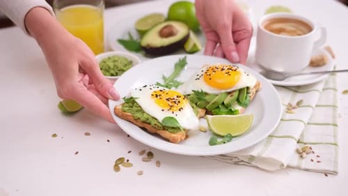 Delicious Breakfast with Avocado Toast, Eggs, and Juice