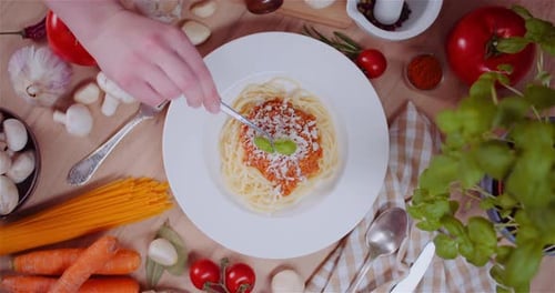 Decorating Pasta Bolognese with Basil