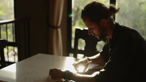 Artist Drawing on Tablet at Bright Indoor Table