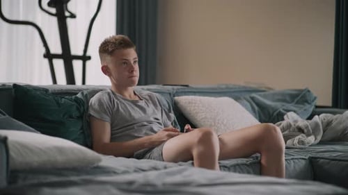 Teen Lounging Comfortably on Couch