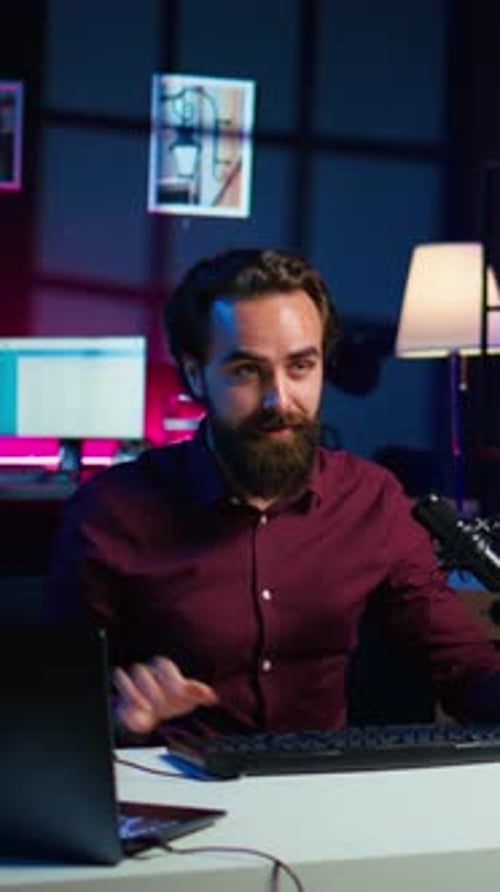 Young Adult Presenting Computer Equipment at Desk