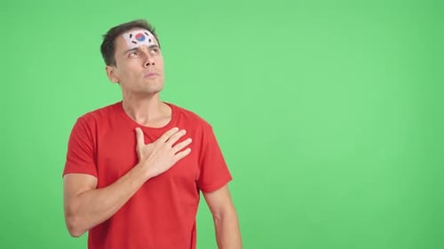 Man Listening to the South Korea National Anthem with Solemnity