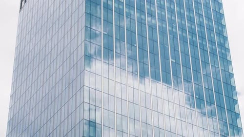 Time Lapse of a Glass Skyscraper with Clouds Reflected in the Office Windows