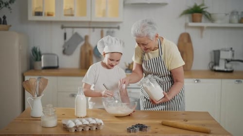 Grandmother and Child Baking Together in Kitchen