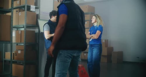 Inventory Specialist Gives Instructions to Warehouse Employees Uses Tablet Computer