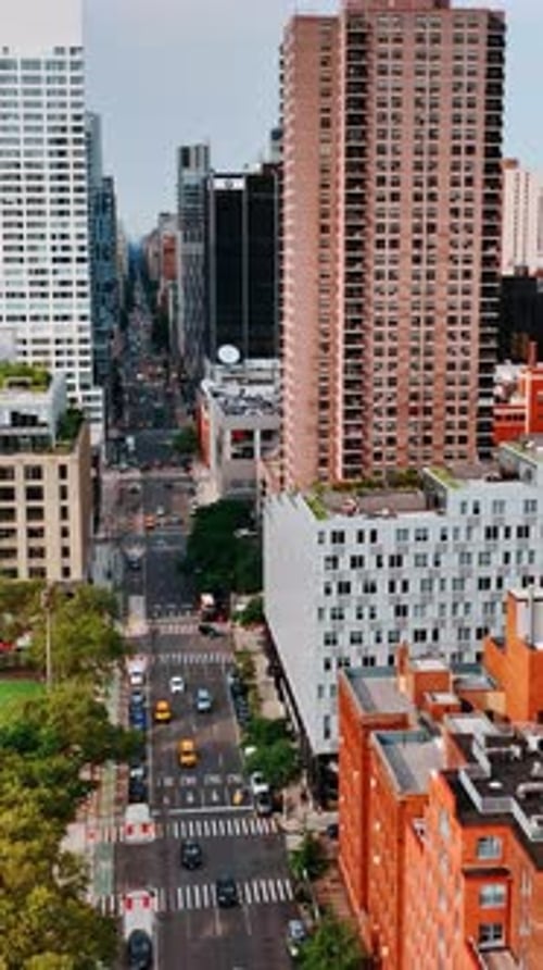 Footage above the busy wide road going along futuristic modern architecture of New York