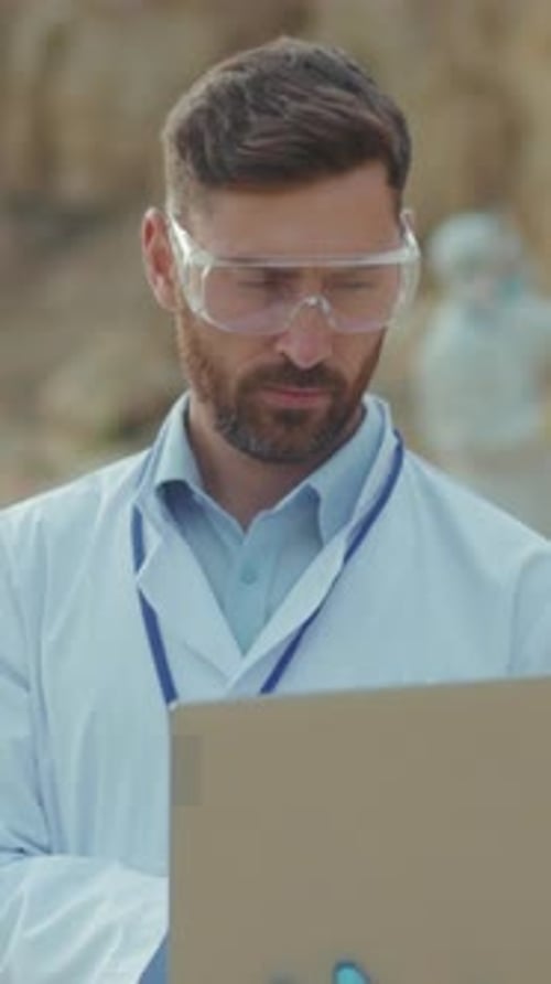 Man Reviews Safety Procedures Diligently Skilled Engineer Observes Results During Field Assessment