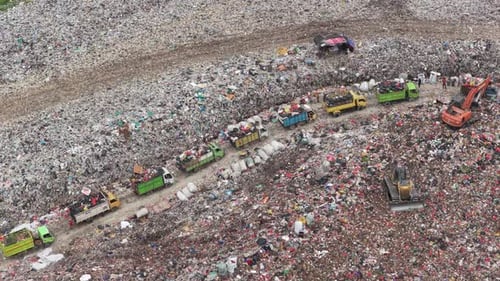 Aerial view of garbage trucks at landfill site