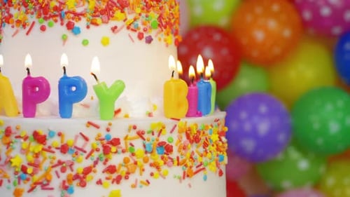 Celebratory Birthday Cake with Colorful Candles and Balloons