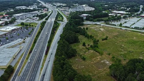 Aerial birds eye shot alone american highway with traffic during cloudy day in suburb area of Atlant