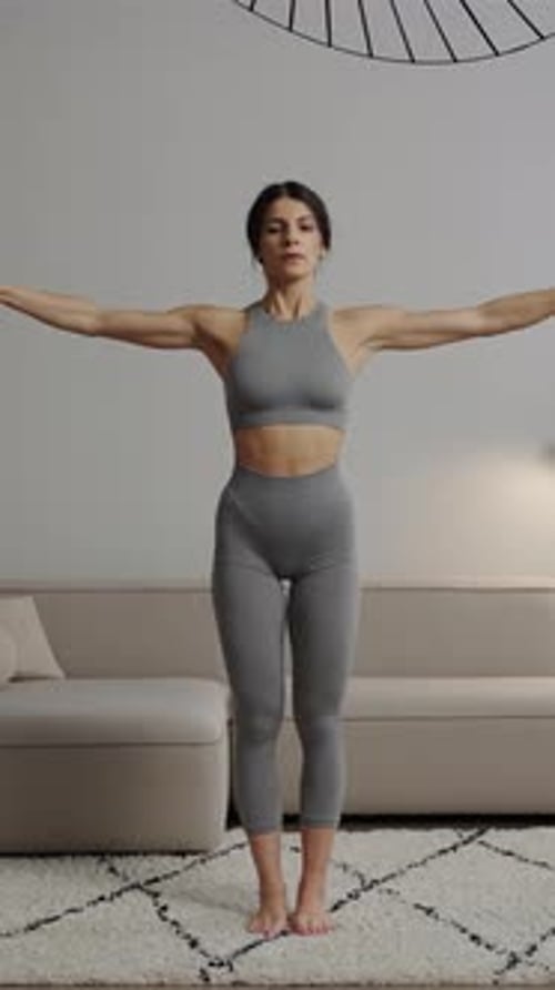 Athletic Woman Exercising with Dumbbells in Modern Home