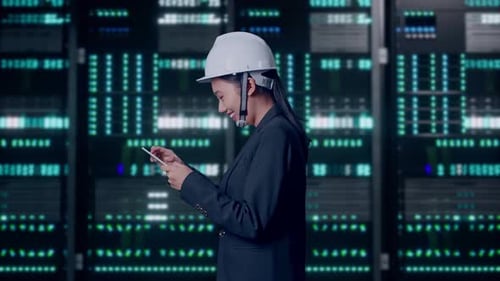 Asian Businesswoman Use Tablet While Walking in Data Center