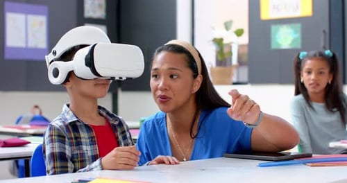 In school, teacher guiding student using VR headset in classroom activity