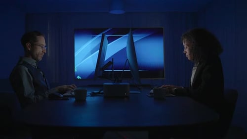 Workers Analyze Data on Computers Late at Night