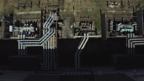 Aerial view of high-voltage transformer at substation near thermal power plant