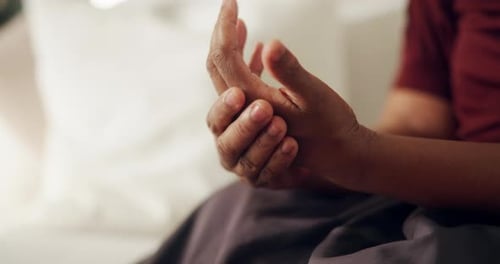 Hands, pain and woman at house with discomfort, inflammation and symptoms of osteoarthritis