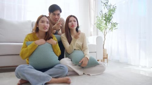 Friends Watching Television Together in Bright Living Room