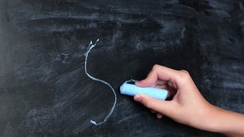 Child Hand Writing Word School on Blackboard