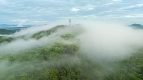 4K Hyperlapse of Mountain Peaks Covered in Fog with Signal Station Above