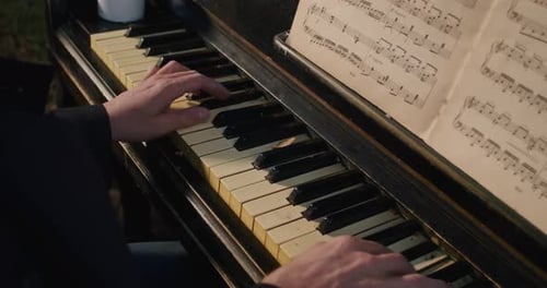 Hands Play Keys of an Old Piano