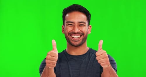 Face, thumbs up and happy man in green screen studio background with hand, like sign and thank you