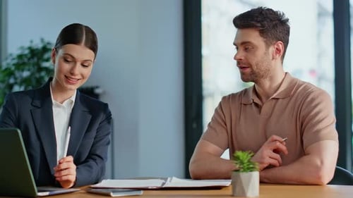 Real Estate Customer Signing Deal with Smiling Woman Realtor in Office Closeup