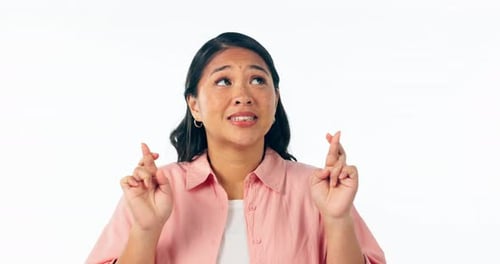 Hope, woman and fingers crossed in studio with anxiety for news, feedback