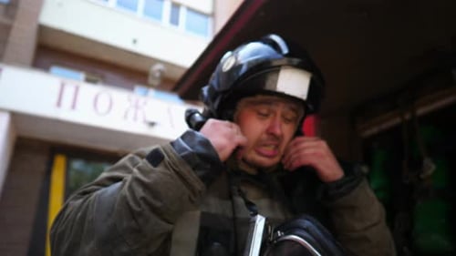 Tired Fireman Removing Mask Inside Fire Truck