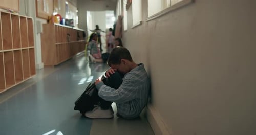 Depression, education and student boy in hallway of school for development or learning failure