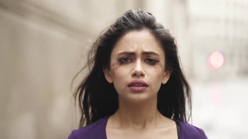 Young middle eastern woman is crying depressed nervous afraid in windy situation close up slowmotion