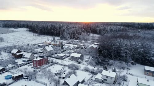 Winter Wonderland A Stunning Aerial View of a SnowCovered Village Bathed in Beautiful Sunset Light