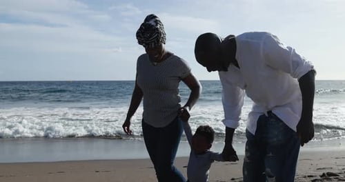 Happy African Couple Walking on the Beach with Little Son - Black