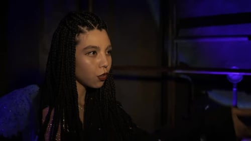Young Adult Woman with Braids Posing at Night